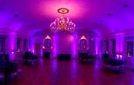 Ornate chandelier with dramatic purple ambient lighting